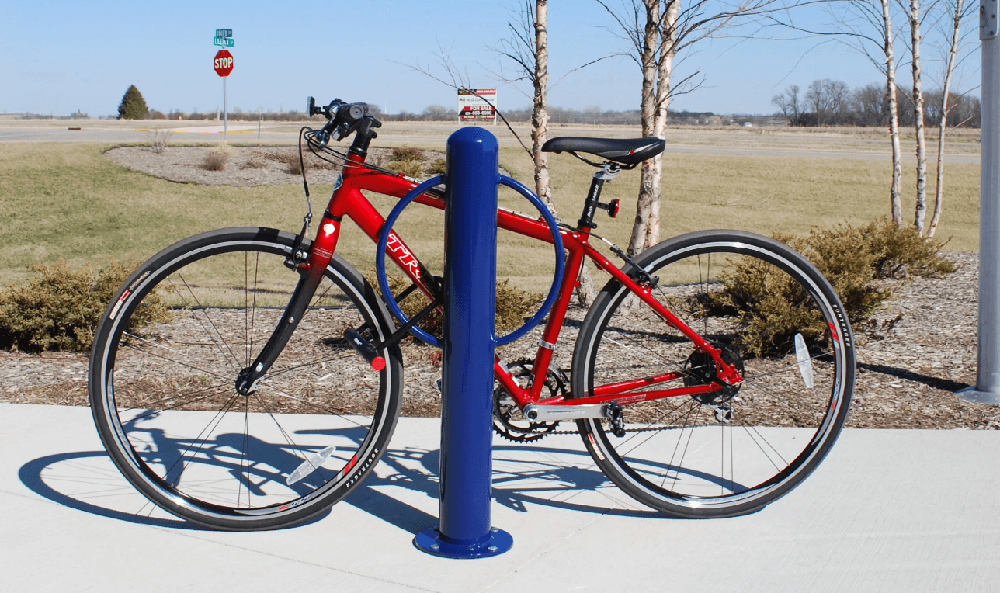 Bike locked with a U-lock securing the frame and wheel to a fixed post rack demonstrating best practice for theft prevention